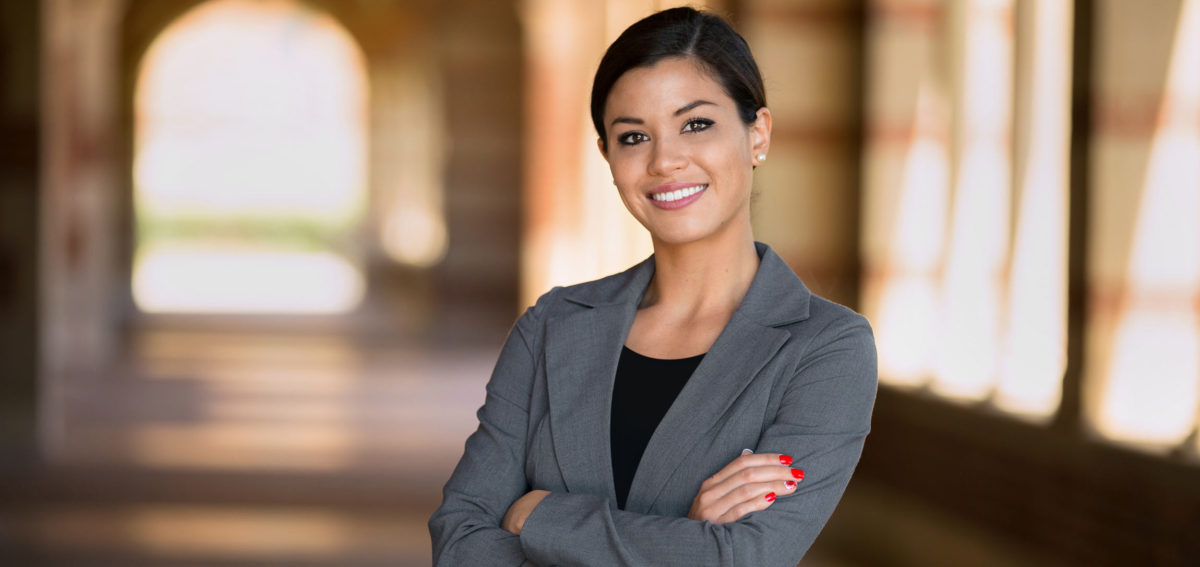 Beautiful Young Latina Businesswoman With A Pen And A Notebook Stock Photo